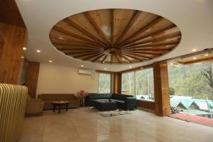a large living room with a large wooden ceiling at The Udit By West Western - Central Heated and Air Cooled - River View & Roof Top cafe & Bar in Kasol +61 photos