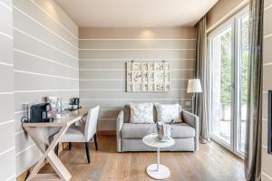 a living room with a table and a chair at Tenuta De L'Annunziata - Natural Relais in Uggiate
