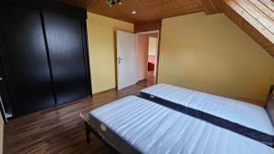 a bedroom with two beds in a room with wooden floors at Ferienwohnung Lippewiesen in Lippetal