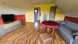 a living room with a couch and a table at Ferienwohnung Lippewiesen in Lippetal