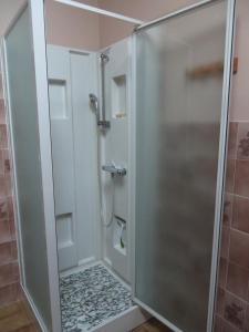 a shower with a glass door in a bathroom at APPARTEMENT de PAULA in Jougne +46 photos