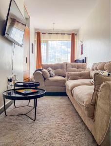 a living room with a couch and a table at SympaHome in Kiambu