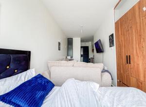 a living room with a couch and a bed at SympaHome in Kiambu