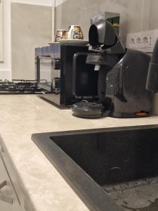 a kitchen with a coffee machine on a counter at Studio Maria in Bucharest +2 photos