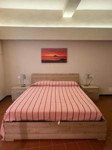 a bedroom with a bed and two night stands at Ca' di Beppe in Albenga