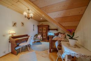 a living room with a piano and a bedroom at Adlerhorst in Bad Wörishofen