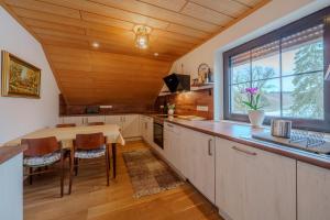 a kitchen with a table and a large window at Adlerhorst in Bad Wörishofen +42 photos