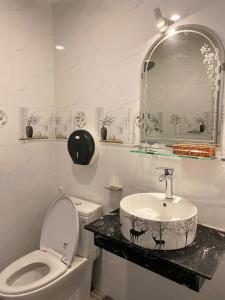 a bathroom with a sink and a toilet and a mirror at Heaven Hostel in Ho Chi Minh City +18 photos