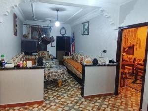 a room with a bed and a table in it at Sidi boulfdyl in Tiznit