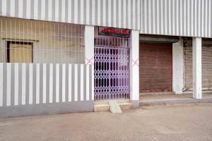 a building with a garage door with a sign on it at Hotel O Sri Ram Guest House in Kendrāparha