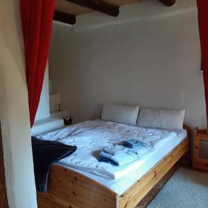 a bed in a small room with a red curtain at Ferienwohnung Willkommen in Seesen