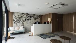 a living room with a couch and a chair at Forest View Studio at Laya Resort in Layan Beach