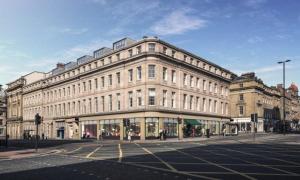 a large building on the corner of a street at Newcastle City Centre Apartment in Newcastle upon Tyne