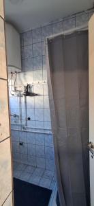 a bathroom with a shower curtain in a room at Apartman DMD in Bijelo Polje