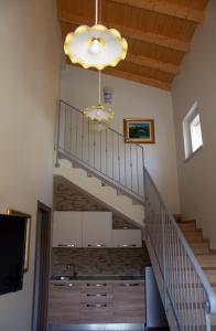 a staircase in a house with a sink and a chandelier at La Radice in Paganica