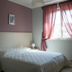 a bedroom with a bed and a window at La Radice in Paganica +28 photos