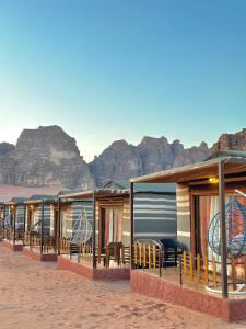 eine Reihe von Resorts in der Wüste mit Bergen im Hintergrund in der Unterkunft Camp sunset in Disah + 7 Fotos