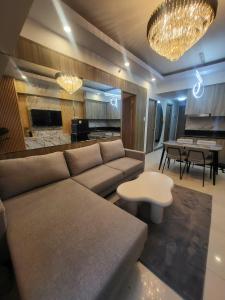 a living room with a couch and a table at matthew's cozzy staycation suit in Sampong +8 photos