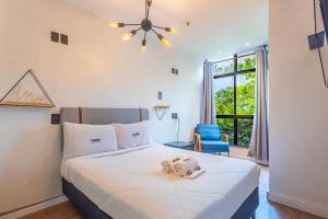 a bedroom with a large bed with a ceiling fan at More Ipanema Hostel in Rio de Janeiro +75 photos