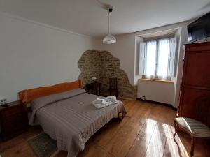 a bedroom with a bed and a stone wall at Bellavista in Badia Prataglia