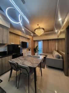 a living room with a table and a couch at matthew's cozzy staycation suit in Sampong