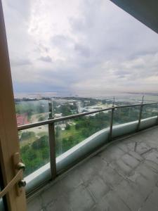 a view of a balcony with a view of the ocean at matthew's cozzy staycation suit in Sampong