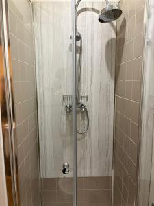 a shower with a glass door in a bathroom at Hotel Kapitán in Žatec +28 photos