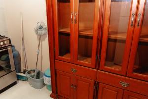a wooden cabinet with glass doors in a kitchen at Departamento 1 centro de la ciudad in Santo Domingo de los Colorados +16 photos