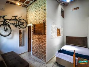 a bedroom with a bike hanging on the wall at hostel Bike Point Caraguatatuba in Caraguatatuba