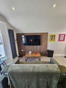a living room with a couch and a table at West Strand Snug in Portrush