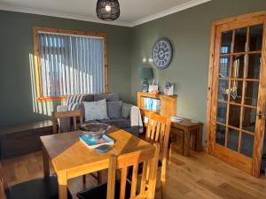 a living room with a table and a couch at The Homer in Kilmuir