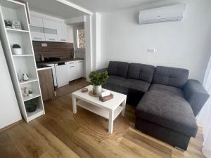 a living room with a couch and a table at Duna Panoráma Vendégház in Mohács +22 photos