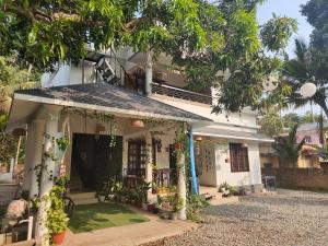 a white house with a gazebo at Shamak Homestay Varkala in Varkala
