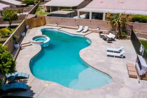 an overhead view of a swimming pool with lounge chairs at Desert Escape - Private Pool - Spa in Indio
