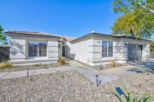 a white house with a driveway in front of it at Desert Escape - Private Pool - Spa in Indio