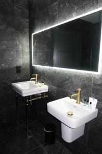 a bathroom with two sinks and a mirror at House 15 in Kenmare +44 photos