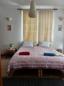 a bedroom with a large bed with two pillows on it at Samadhi House in Burhānilkantha