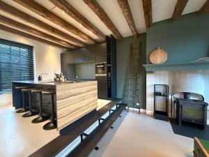 a large kitchen with a counter and a stove at B&B Louwi in Breugel