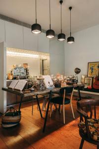 a dining room with a table with chairs and lights at Rosário Suites Townhouse in Porto