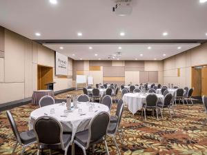 a conference room with tables and chairs and a podium at Peppers Salt Resort & Spa in Kingscliff
