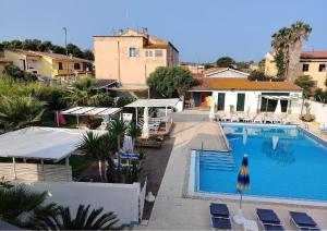an image of a swimming pool at a resort at Le Palme Holidays in Palmadula