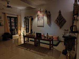 a living room with a table and a couch at Shamak Homestay Varkala in Varkala