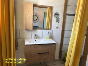 a bathroom with a sink and a mirror at Le Cannelle in Saint-Pierre +83 photos