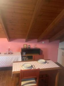 a dining room with a table and two chairs at Chaido's attic in Larisa