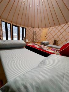 a room with two beds in a tent at Отель 3 in Kurmenty