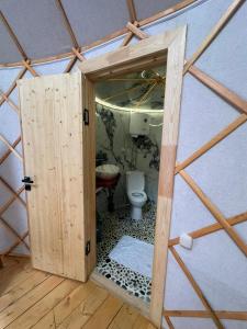 an open door to a bathroom with a toilet at Отель 3 in Kurmenty