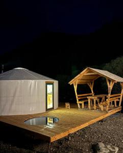 a yurt with a wooden deck and a tent at Отель 3 in Kurmenty