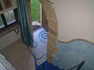 a bathroom with a painting of a wave on the wall at Casa Vacanza La Valle in Urbino