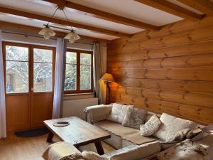 a living room with a couch and a table at Dębowa Dziupla in Białowieża