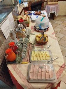 a table with food and a cake on top of it at Albergo Tre Stelle in Marina di Grosseto